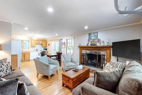 a living room with a couch and a fireplace at Lighthouse Lodge in Eastham