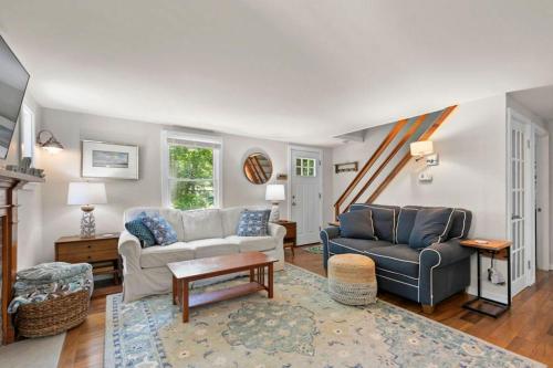 a living room with two couches and a staircase at Dolce Vita in Falmouth
