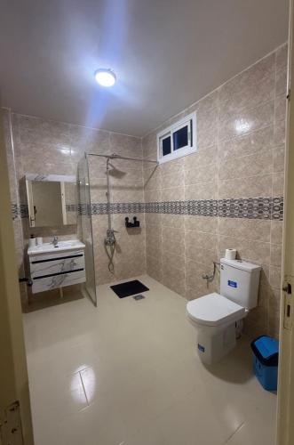 a bathroom with a toilet and a shower and a sink at Villa Familiale Exception in Saïdia