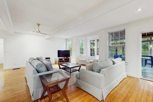 a living room with two white couches and a table at Family Tides in Barnstable