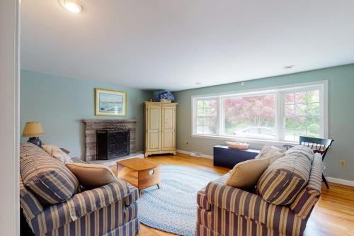 a living room with two couches and a fireplace at Beach Happy in Harwich Port