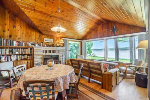 a dining room with a table and a fireplace at Serenity in Honor