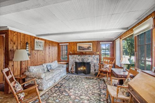 a living room with a couch and a fireplace at Cedar Cot & Cedar Tot in Beulah