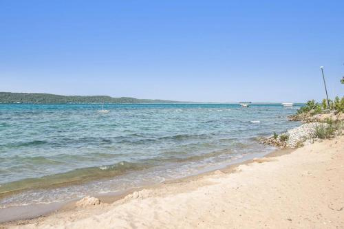 a sandy beach with a view of the ocean at Cedar Cot & Cedar Tot in Beulah