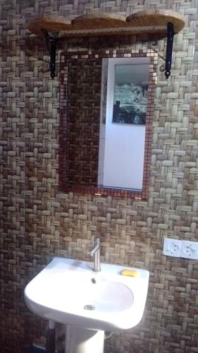 a bathroom with a white sink and a mirror at Cafe Romantique - Landhouse Style in Mérina