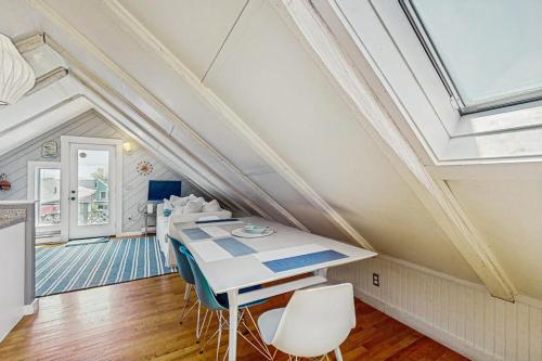 a dining room with a long table and chairs at Monument View in Provincetown