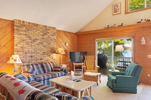 a living room with a couch and chairs and a tv at Walloon Lake Cottage in Boyne City