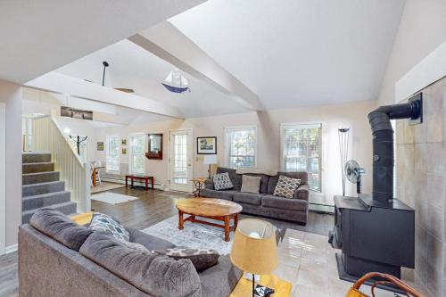 a living room with a couch and a fireplace at Lou n' Lil's in Glen Arbor
