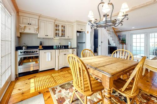 a kitchen with a wooden table and chairs at Hammock Hideaway in Mashpee