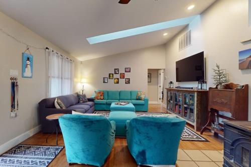 a living room with a blue couch and a tv at Four Bedrooms & a Beach in Lakeside