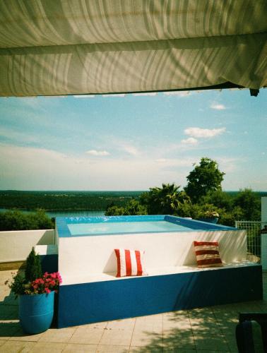a swimming pool with two pillows on a patio at Casa Lusa Montargil in Montargil