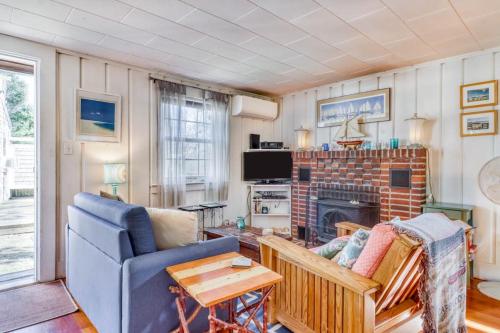 a living room with a couch and a fireplace at Sea la Vie in Harwich