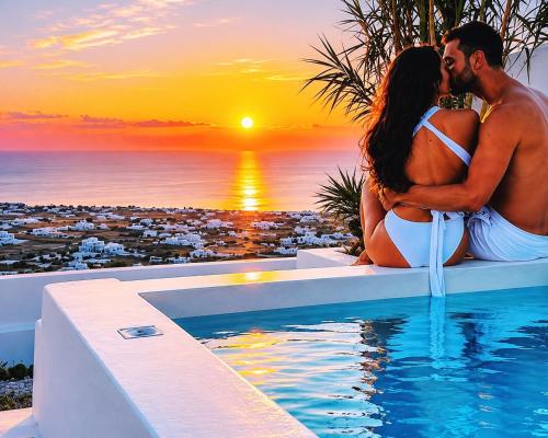 a man and a woman sitting next to a swimming pool with a sunset at Martynou View in Pyrgos
