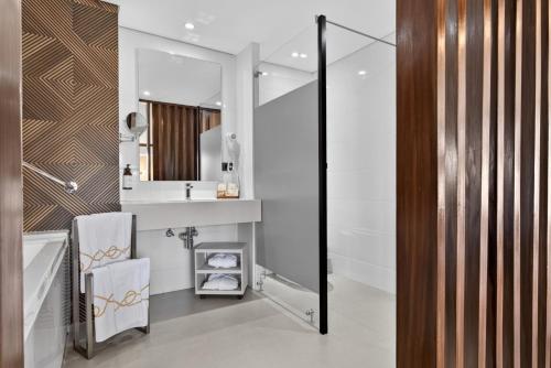 a bathroom with a sink and a mirror at Cafe Hotel Medellín in Medellín