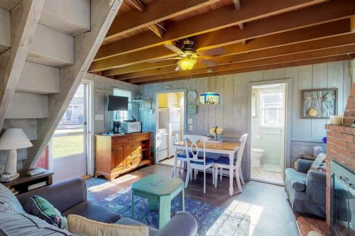 a living room with a table and a dining room at Sea Coast Cottage in Barnstable