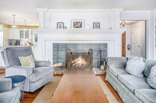a living room with two couches and a fireplace at Birdie Bungalow in Saugatuck