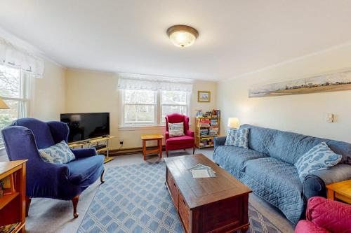 a living room with a blue couch and two chairs at Nauset Beach Dream in Orleans