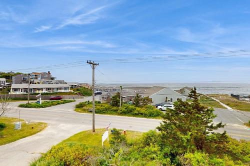 an aerial view of a street with houses and the ocean at The Pagoda Perch in North Truro