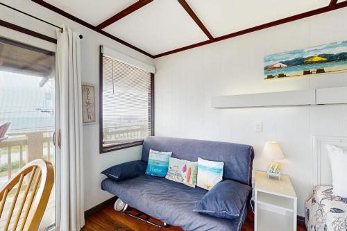 a blue couch in a room with a window at The Pagoda Perch in North Truro