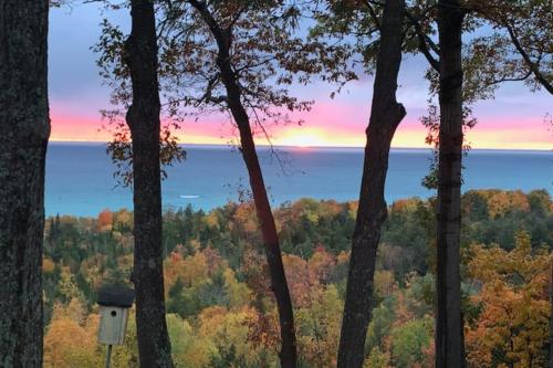 a view of the lake through the trees at Tally-Sun on the Bluff in Harbor Springs