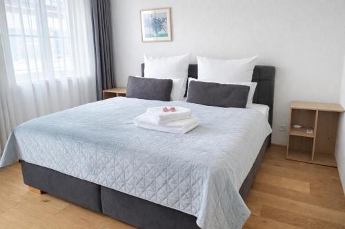 a bedroom with a bed with two towels on it at Casa Rheinblick - Apartment C in Basel