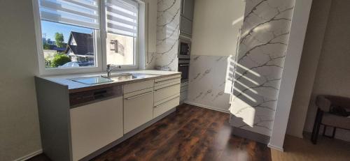 a kitchen with a sink and a window at Lem-Lux in Lemgo