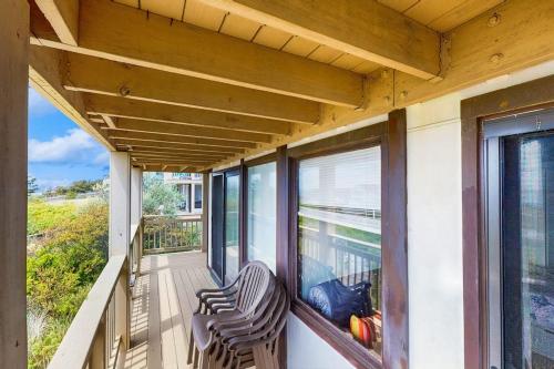 two chairs on a porch with a view of the water at Seashore Escape in North Truro