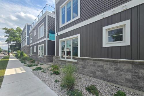 a building with a sidewalk in front of it at Cozy TC Bay Condo in Traverse City