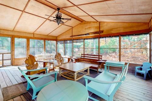 a room with tables and chairs and windows at Absolute Leelanau in Glen Arbor