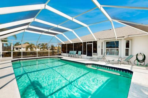 a swimming pool with a pergola on a house at Rotonda Getaway in Rotunda-West