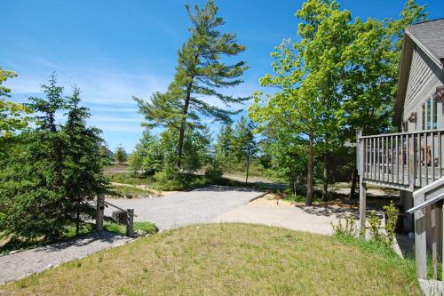 a driveway leading to a house with trees at Hal-Sea-On House in Glen Arbor