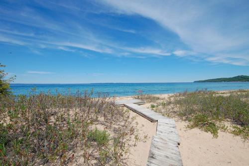 a wooden path through the sand on a beach at Hal-Sea-On House in Glen Arbor