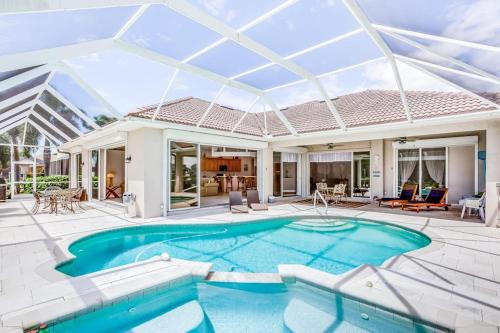 a swimming pool in a house with a glass ceiling at Cape Coral Haven in Cape Coral
