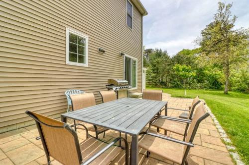 a picnic table and chairs on a patio at Oak Bluffs Beauty in Oak Bluffs