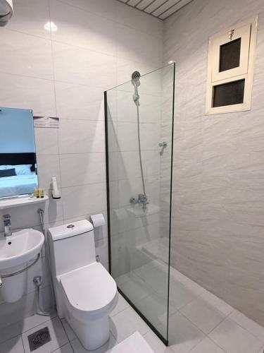 a bathroom with a shower and a toilet and a sink at بستان الورد 2 in Taif