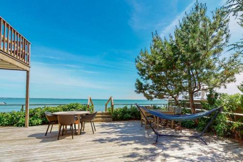 a deck with a hammock and a table and chairs at The Lighthouse in Provincetown