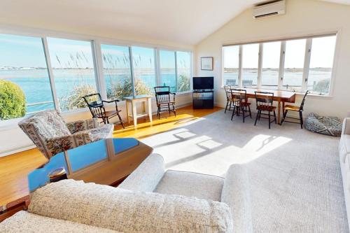 a living room with a couch and a table with chairs at West Dennis Dockside in West Dennis