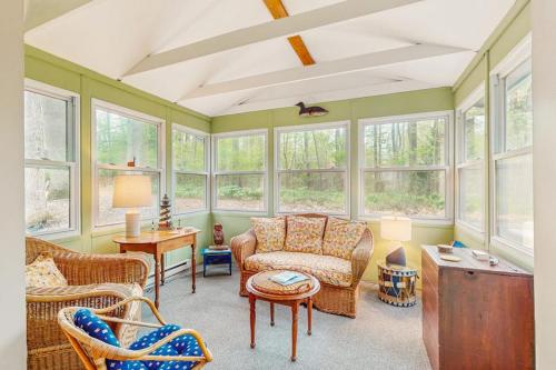 a living room with a couch and chairs and windows at Lake Michigan Adventures in Lakeside