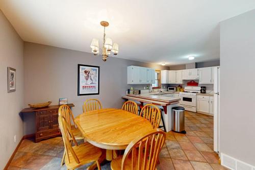 a kitchen with a wooden table and chairs in a room at Crystal Haven in Thompsonville