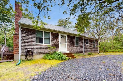 a brick house with a driveway in front of it at Escape in Dennis in Dennis