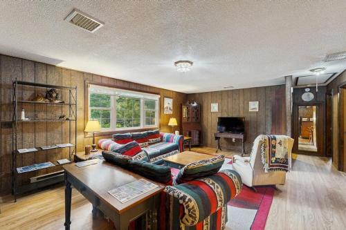 a living room with a couch and a table at The Rootskeller in Oak Bluffs