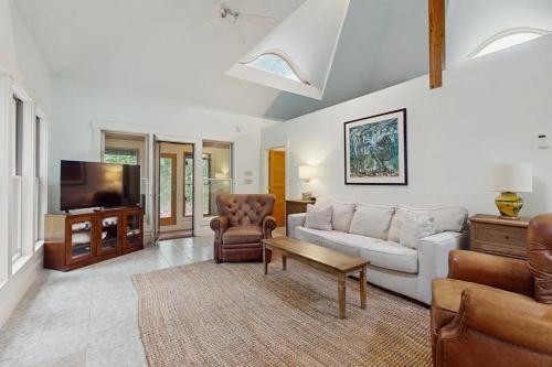 a living room with a couch and a tv at The Lemonade Stand in West Tisbury