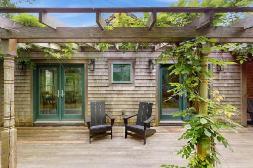 a patio with two chairs and a table on a house at The Lemonade Stand in West Tisbury
