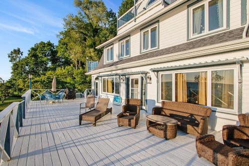 a patio with benches and chairs on a house at Lake Michigan Retreat- Upper Duplex in Benton Harbor