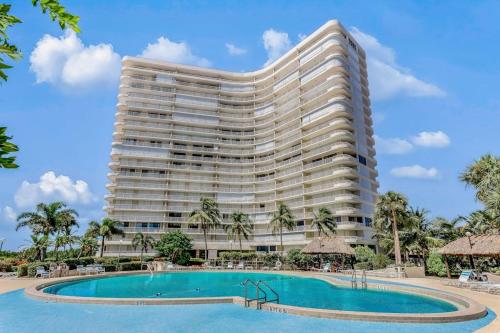 a large hotel with a pool and a resort at Waves & Palms Oasis in Marco Island
