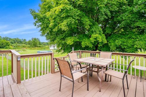 a wooden deck with a table and chairs on it at Fontano Casa in Coloma