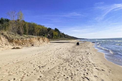 a person walking on a beach near the water at 2nd Base in Sawyer