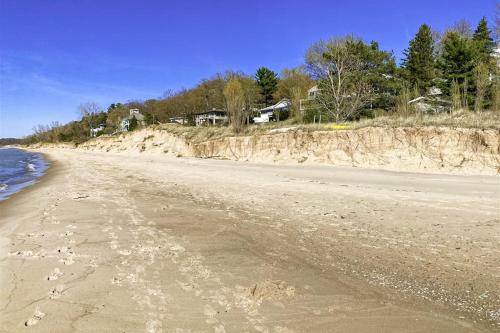 a view of a sandy beach with houses in the background at 2nd Base in Sawyer