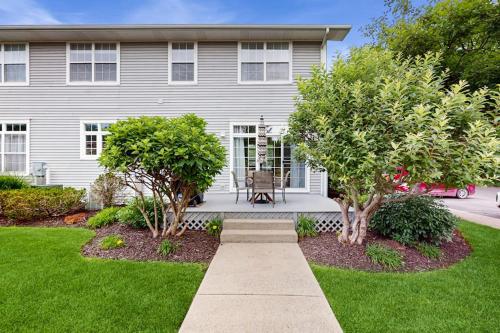 a house with a porch with a bench in the yard at Beacon Court Condo F in Douglas