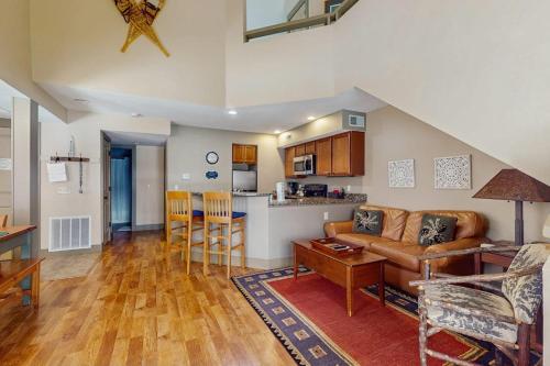 a living room and kitchen with a couch and a table at WinterGreen Condo, #522 in Thompsonville